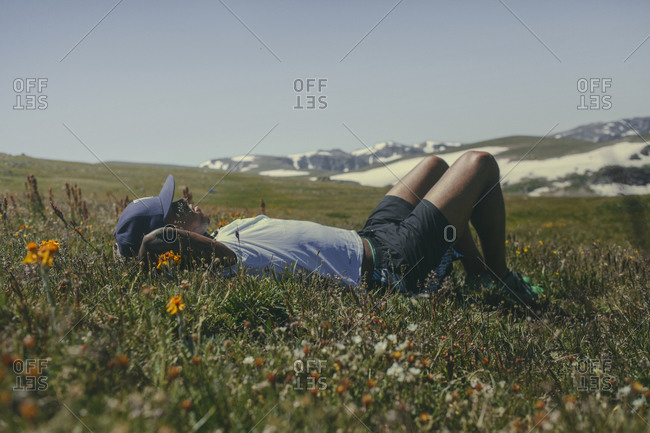 Man soaks up the sunshine in a field in Montana