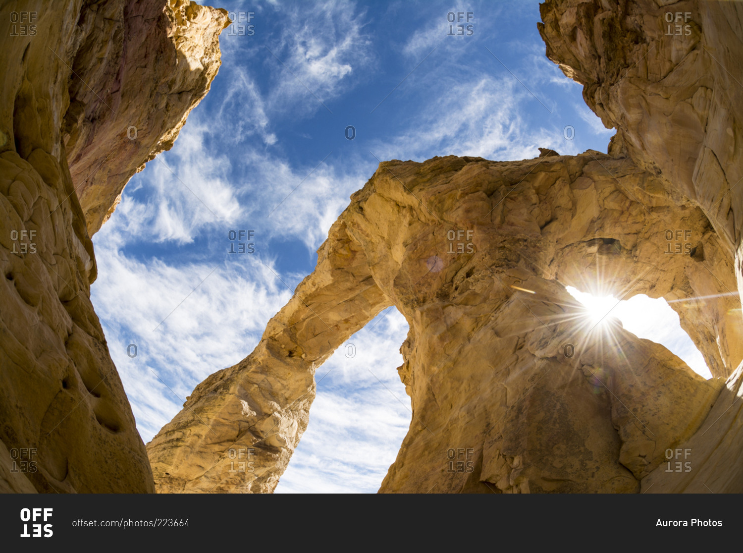 Sun shining through the Grosvenor Arch at the Grand Staircase Escalante National Monument, Tropic, Utah