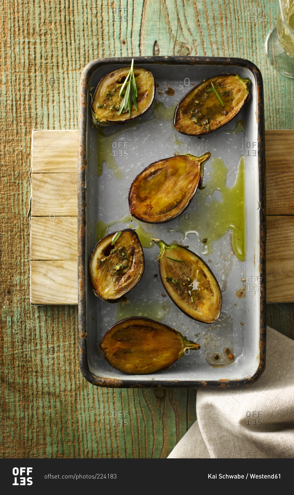 Casserole of fried baby aubergine slices with basil pesto and rosemary