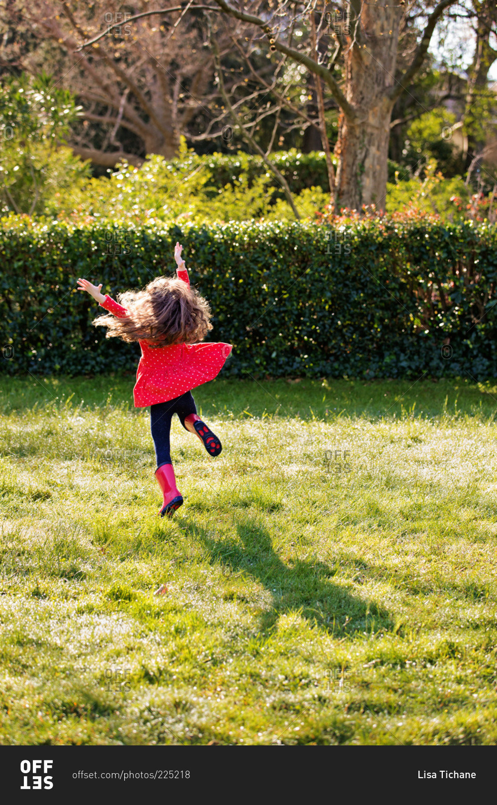 a-little-girl-in-a-red-dress-leaps-in-the-air-stock-photo-offset