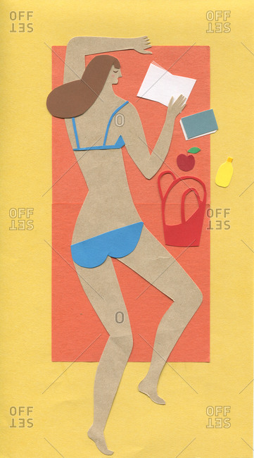 Woman in bikini on beach with book
