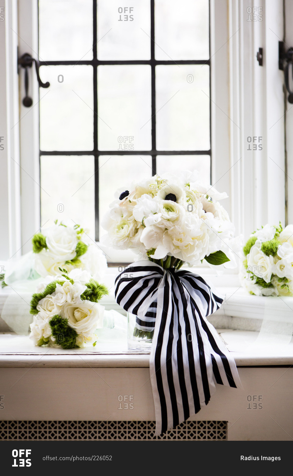 Close-up of bridal bouquets with stripped ribbon