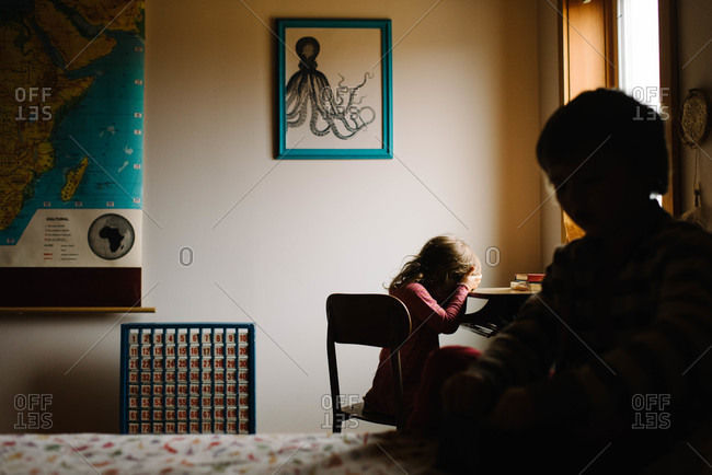 Kids in bedroom silhouetted while playing