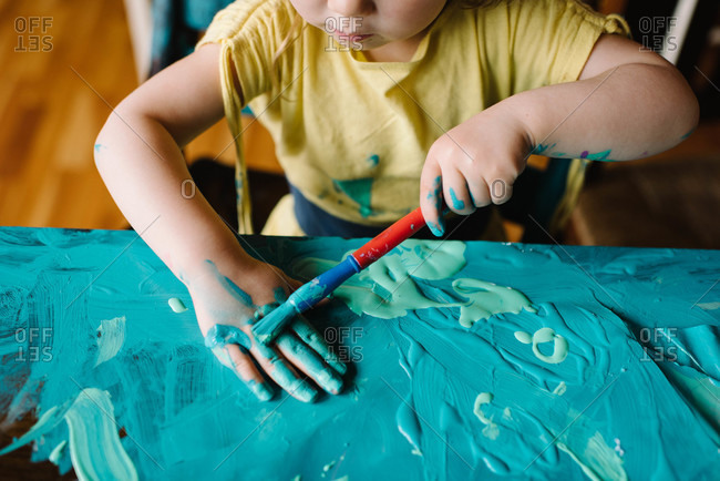 Girl painting herself and table