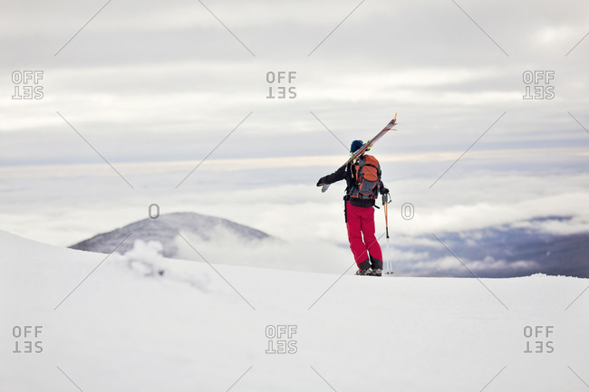 A backcountry skier takes in the view from Burnt Mountain, Maine