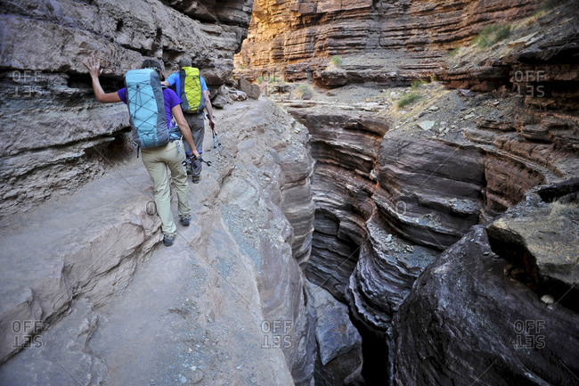 Hikers walk along Deer Creek Narrows in the Grand Canyon