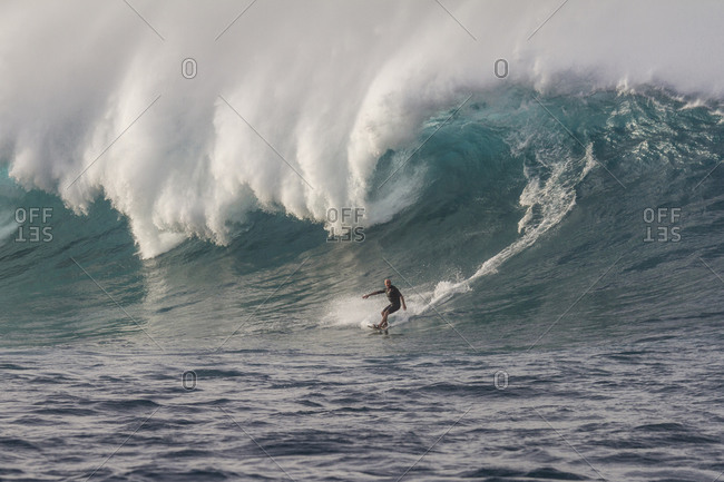 Big wave surfer on a big blue wave