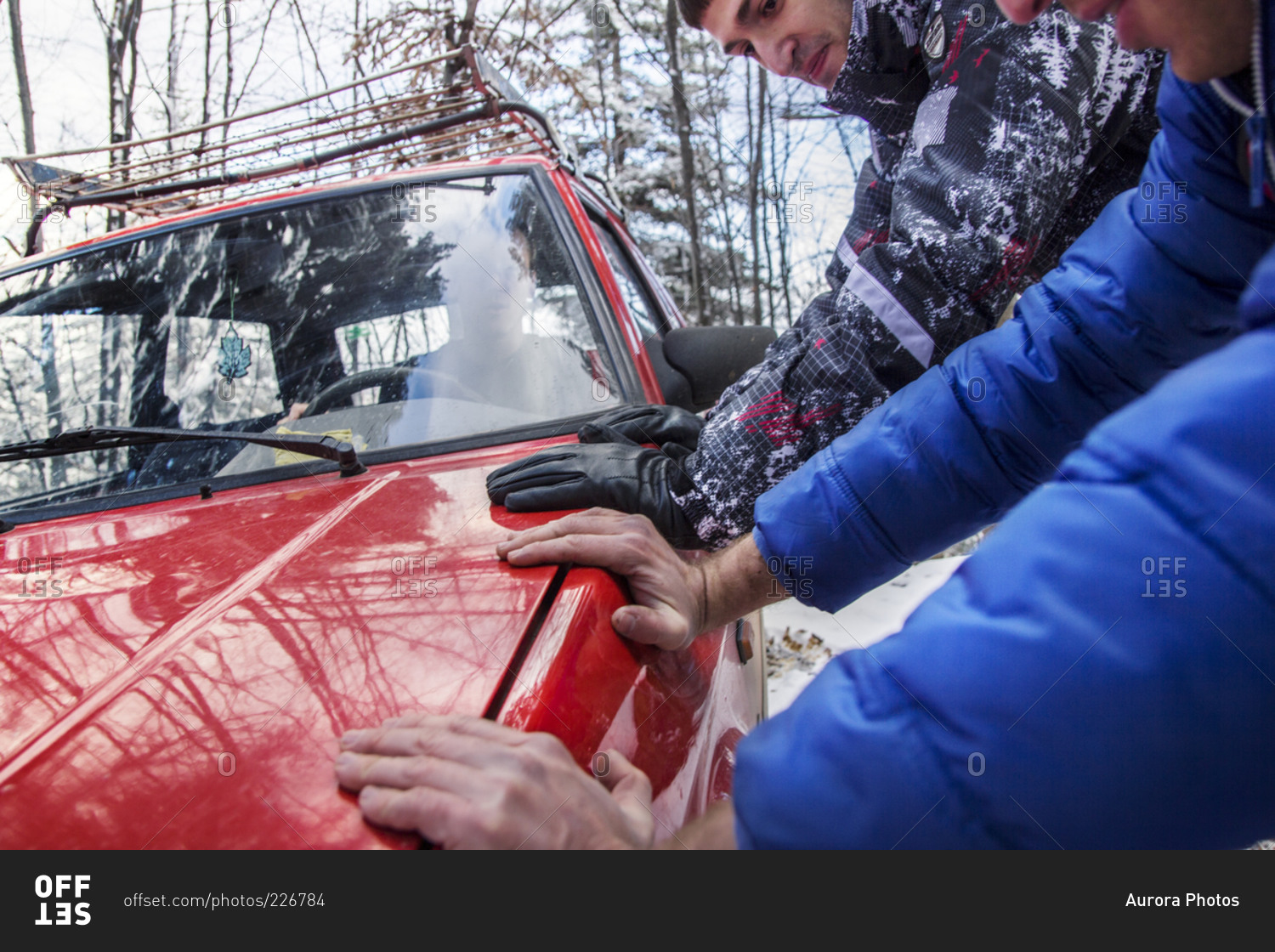 Two men pushed car ona  snow mountain road, Stolovi mountain, central Serbia