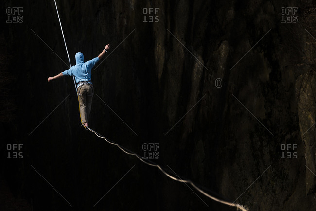 Man walks along a slackline