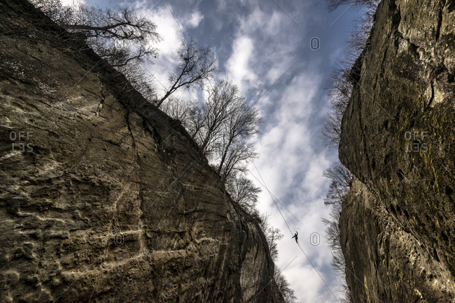 Man walks across a slackline