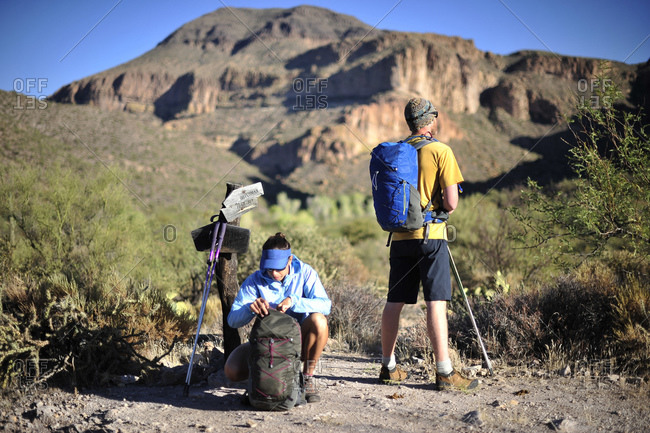 Backpackers hike on the Dutchmans Trail in the Superstition Wilderness Area, Tonto National Forest