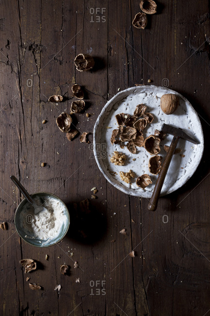 Cracked walnuts and walnut yogurt on a rustic table
