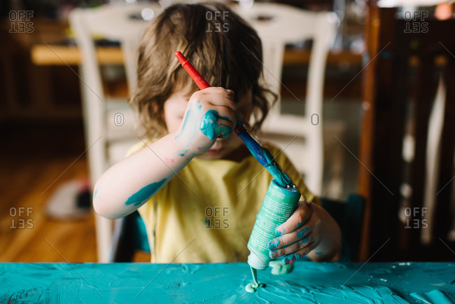 Child making a mess with paint