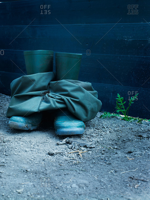 Green boots and waders outside on ground