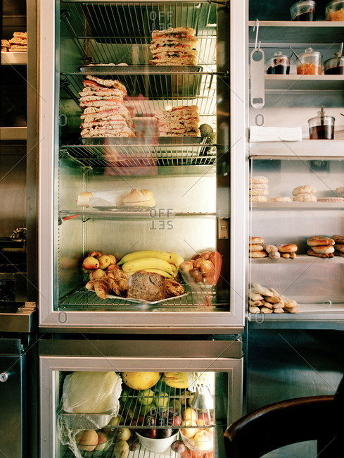 Commercial refrigerators filled with stacks of sandwiches
