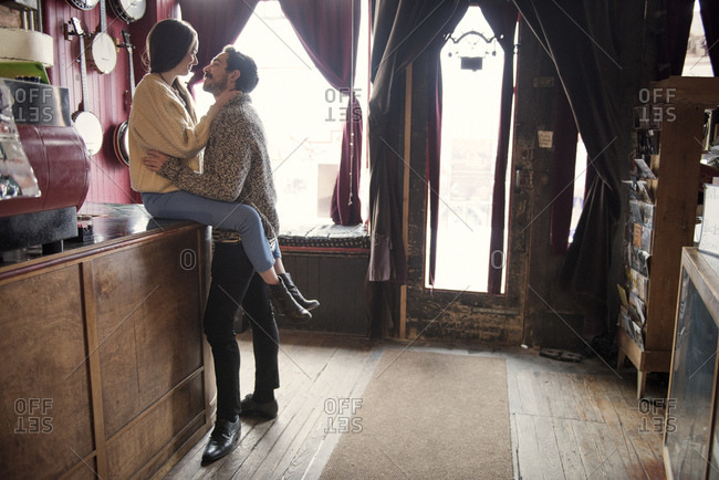 Couple lovingly gazing at cafe counter