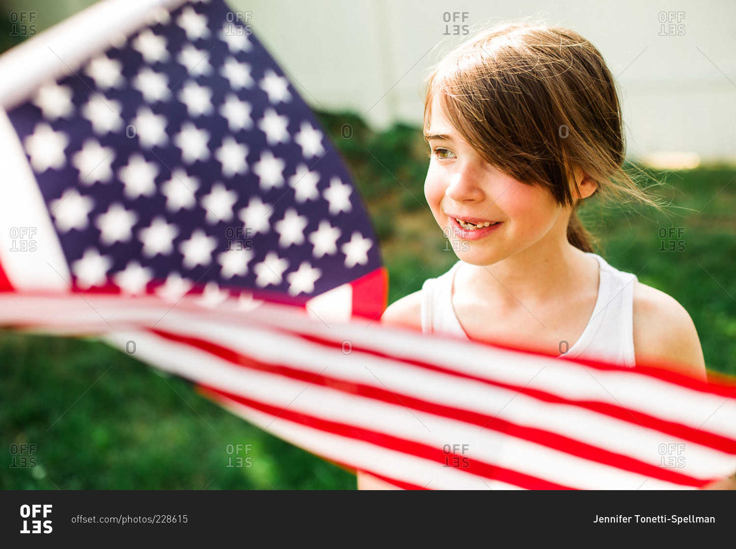 Smiling young girl with an American flag