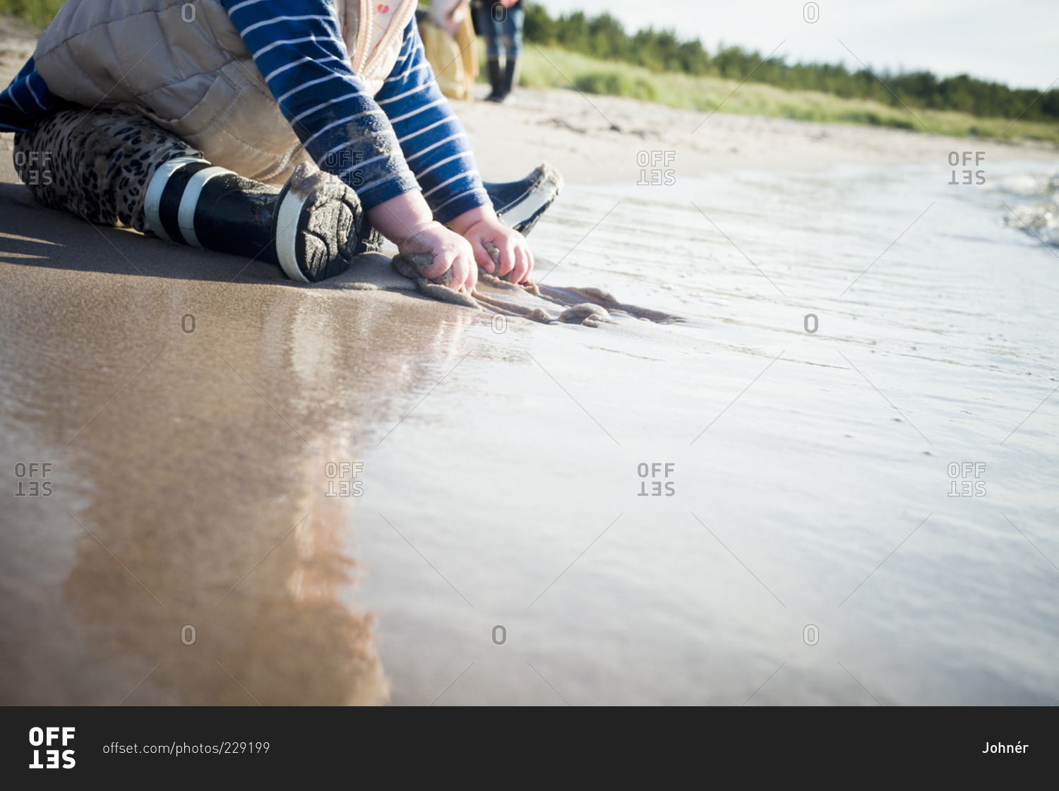 Child playing in sand on beach
