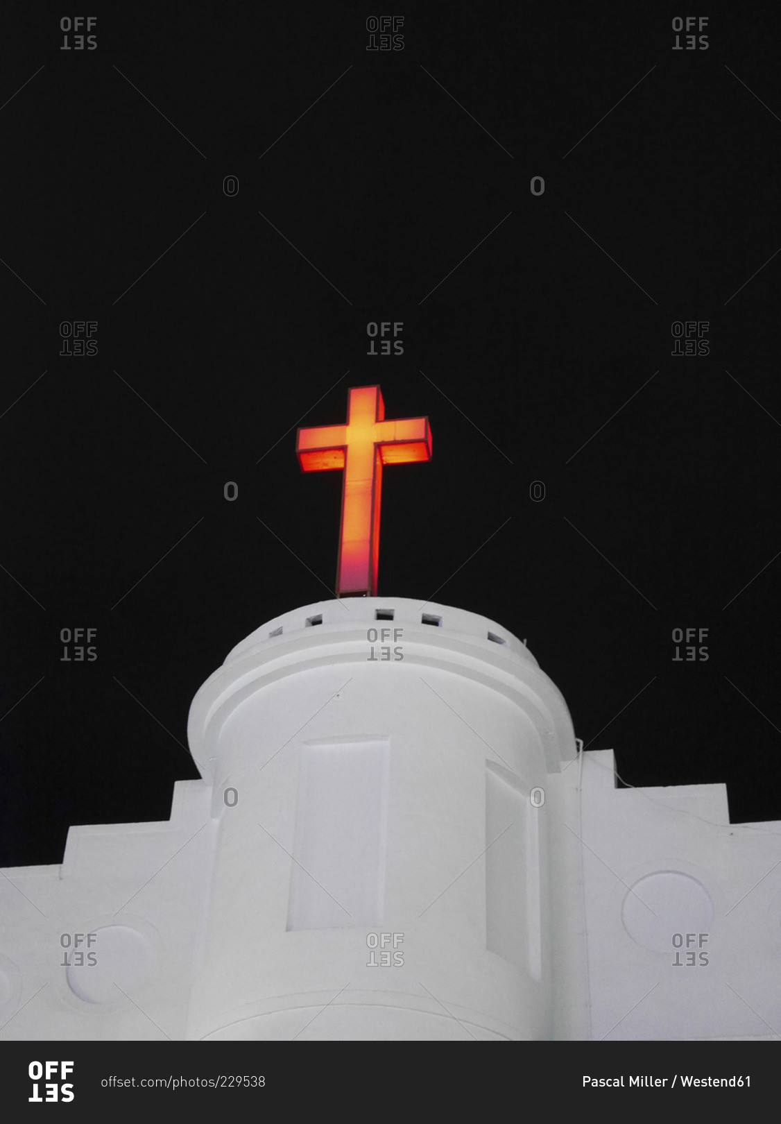 Lighted crucifix on a white church at night, Taiwan