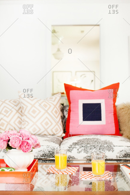 A large pink and blue throw pillow on a couch