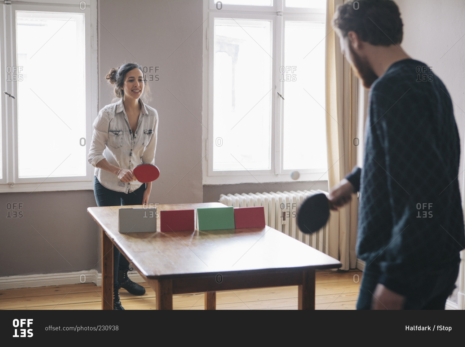 Young couple playing table tennis