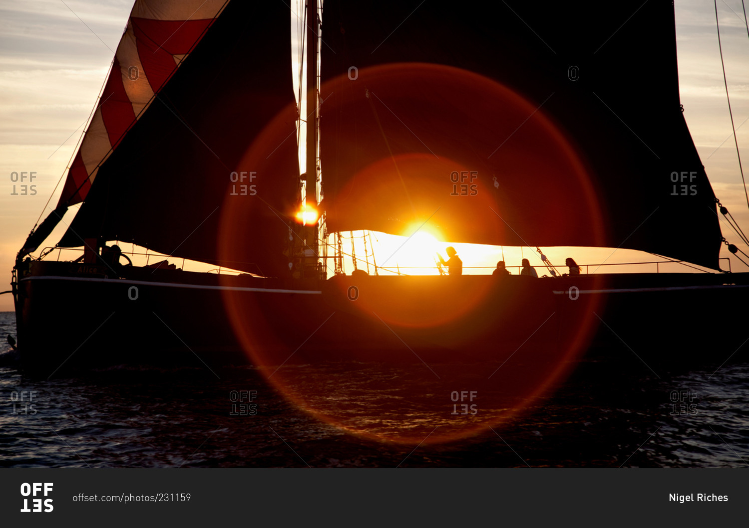 People sailing on a boat at sundown