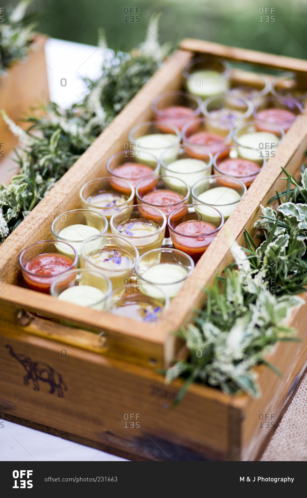 Tray of shot glasses of chilled soups at a wedding reception