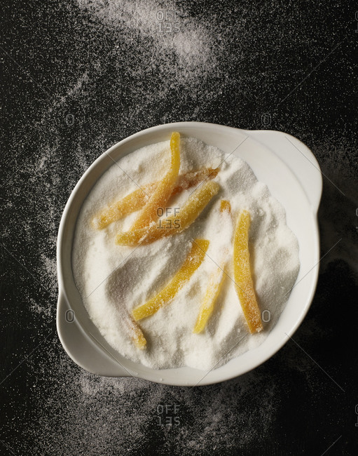 Citrus rinds in a bowl of sugar