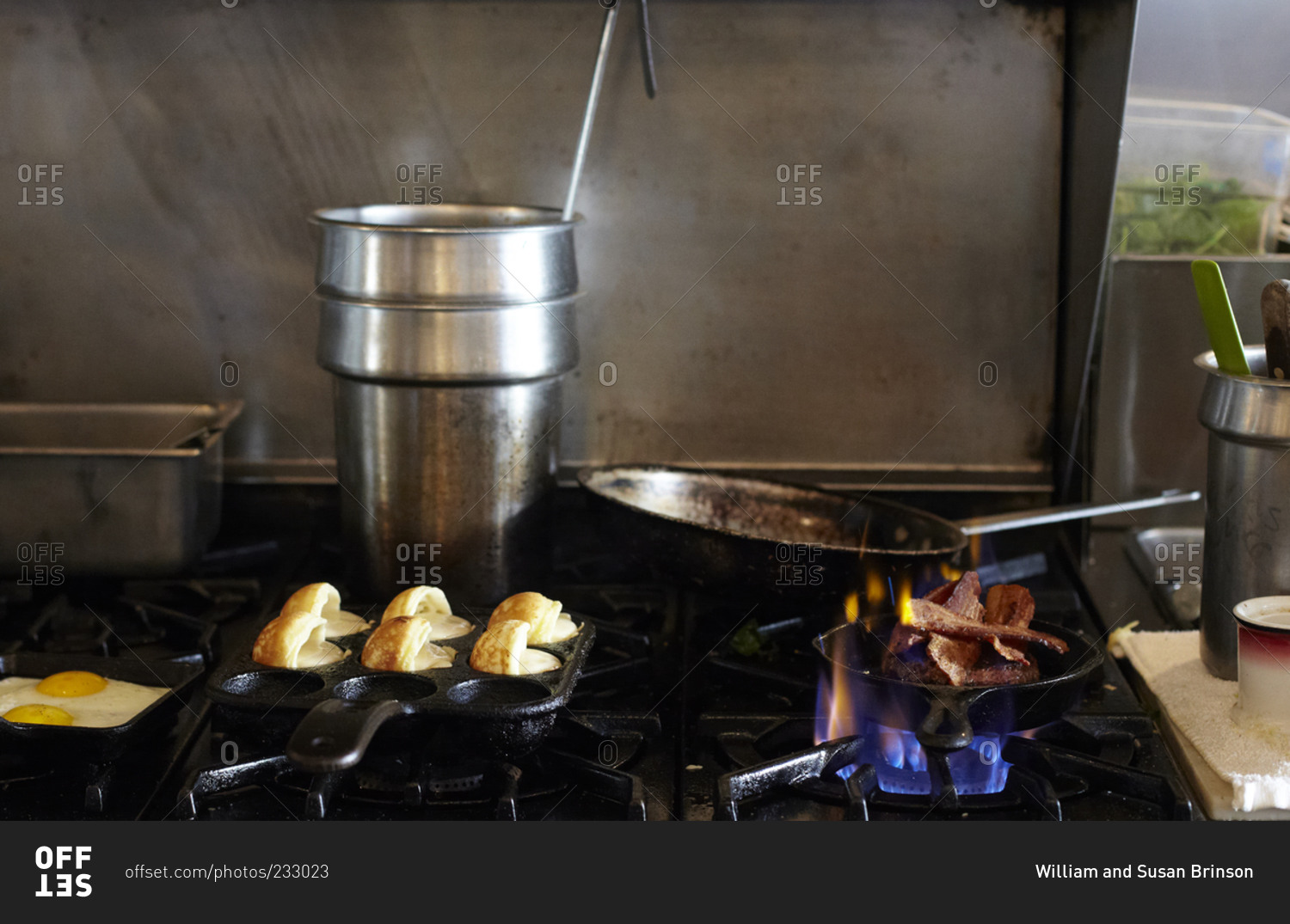 Bacon and eggs cooking on a restaurant stovetop