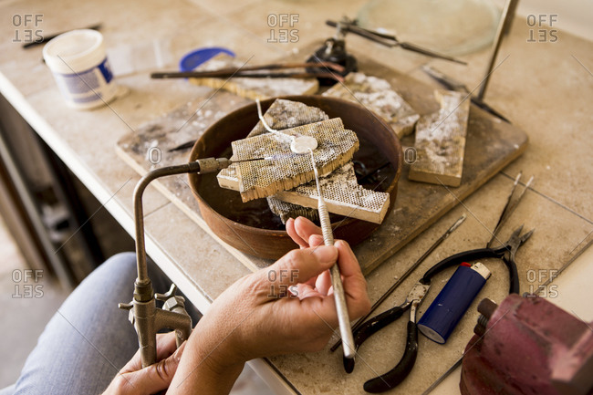 Close up shot of woman making jewelry