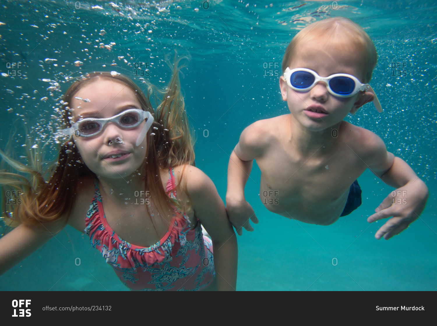 Children swimming together in a swimming pool