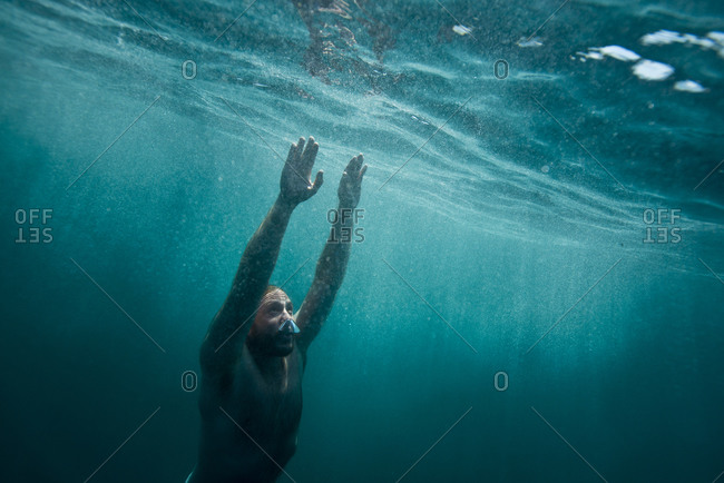 A free diver swims through clear water off the coast of Catalina Island, CA