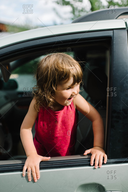 Little girl in the front seat of a car