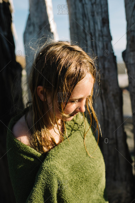 Girl wrapped in a towel on the beach