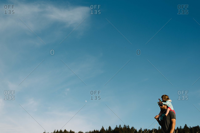 Father carrying his daughter on his shoulders