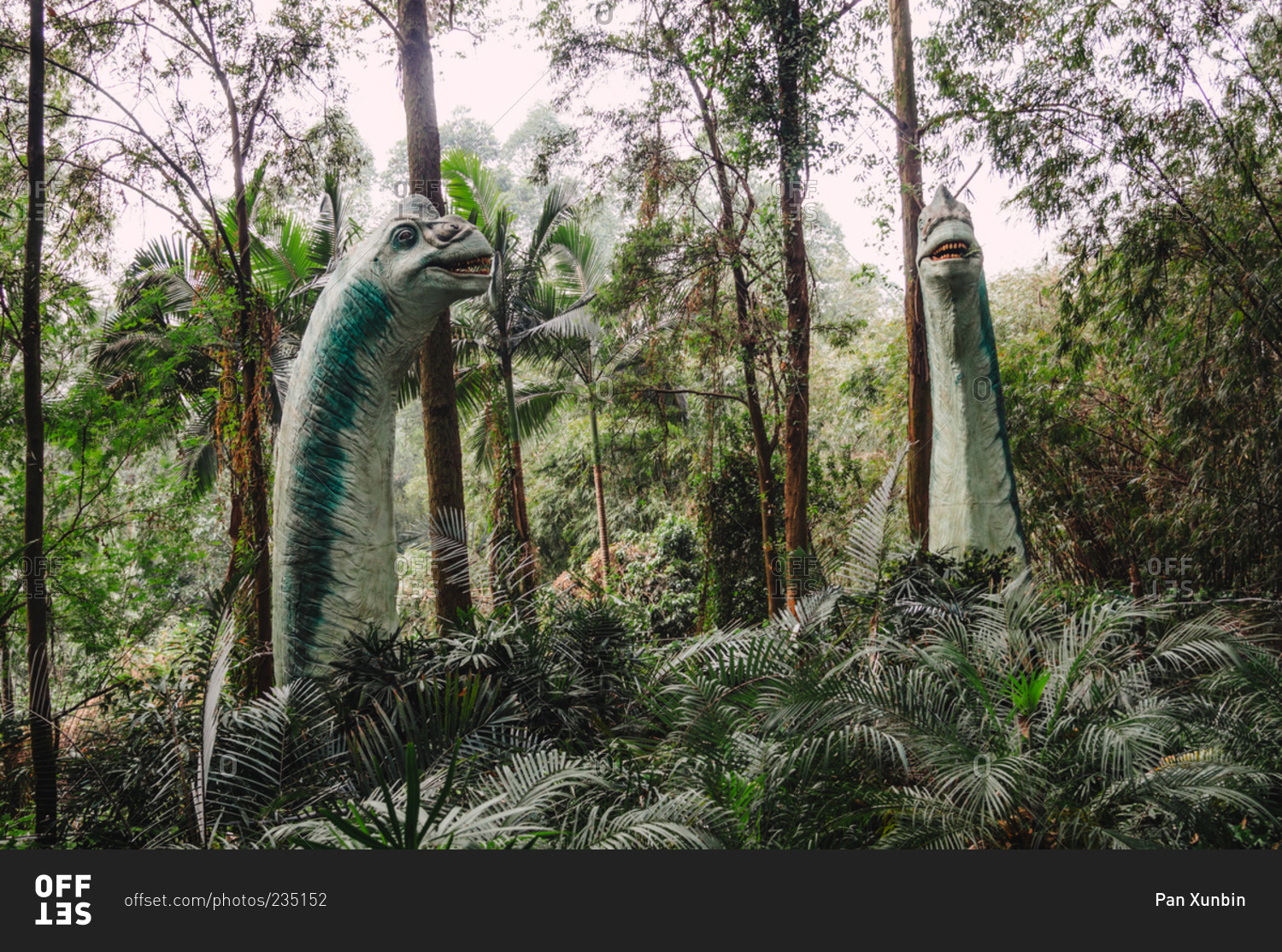 Dinosaur statue in forest
