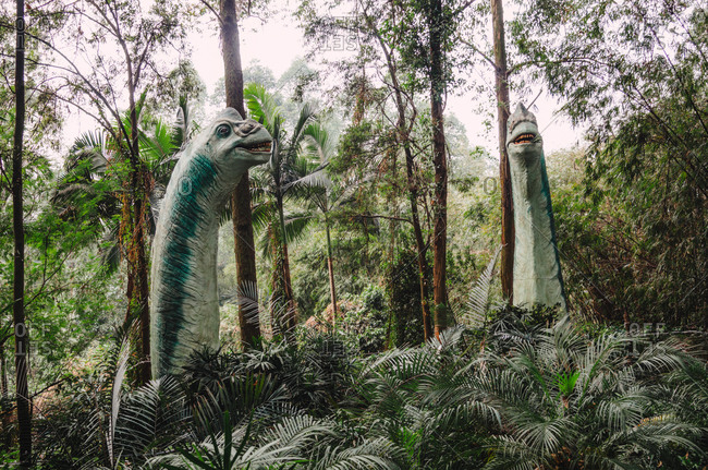 Dinosaur statue in forest