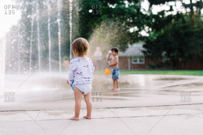 Toddler with bucket at fountains