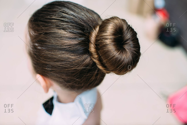 A girl with a large bun ready for a dance recital stock photo - OFFSET