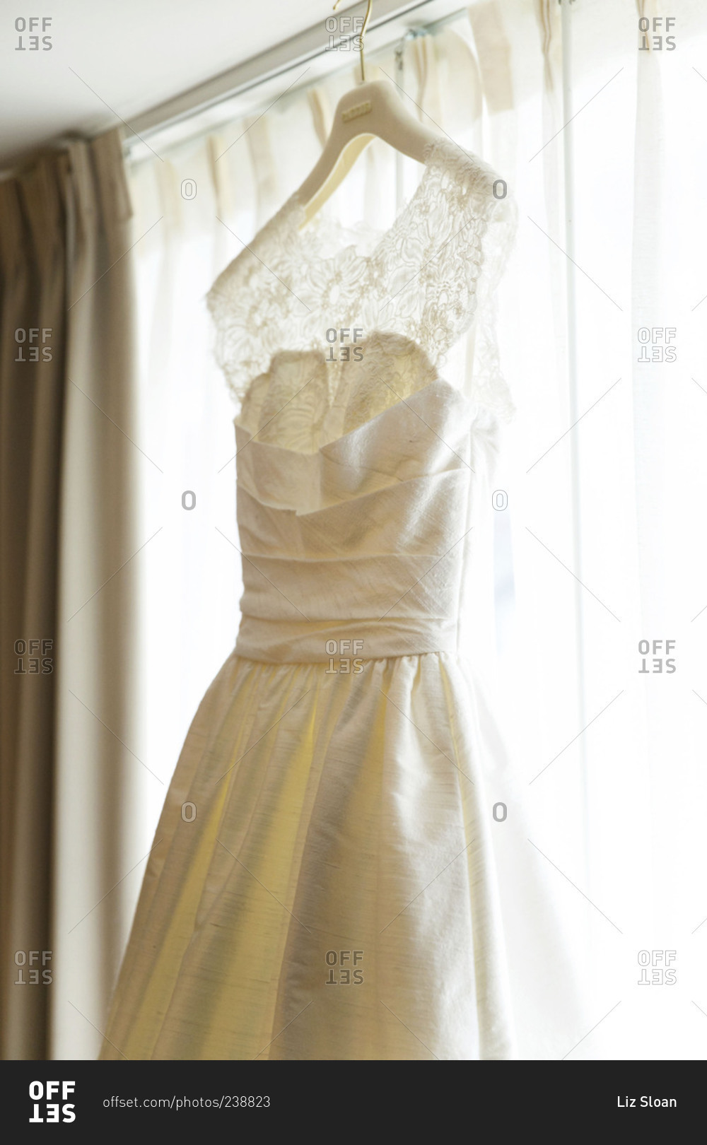 Wedding dress hanging on window