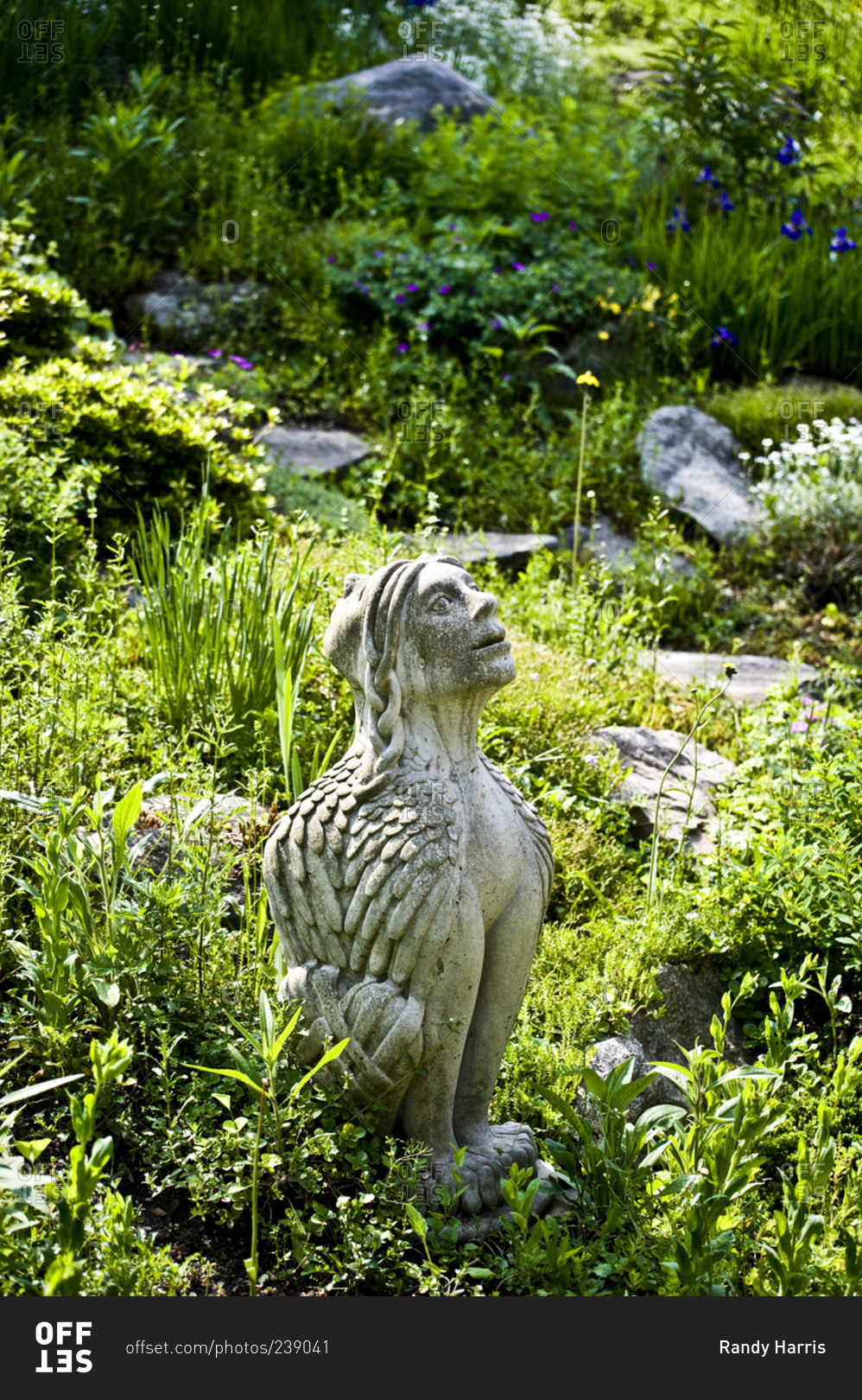 A two faced Sphinx sculpture in a garden