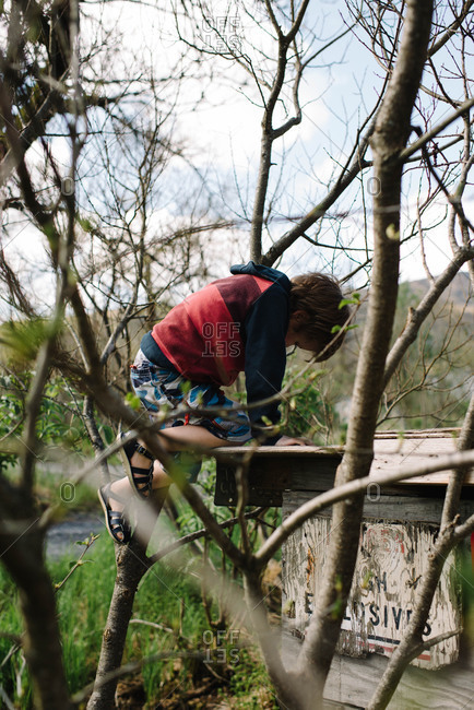 Boy exploring an old wooden structure