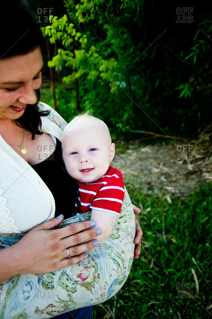 Arnaudville, Louisiana - May 29, 2012: Ashlee Michot carries her baby in a cloth carrier outside her bousillage home