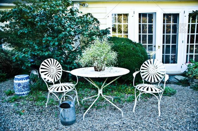 A table and chairs on a back patio at a house