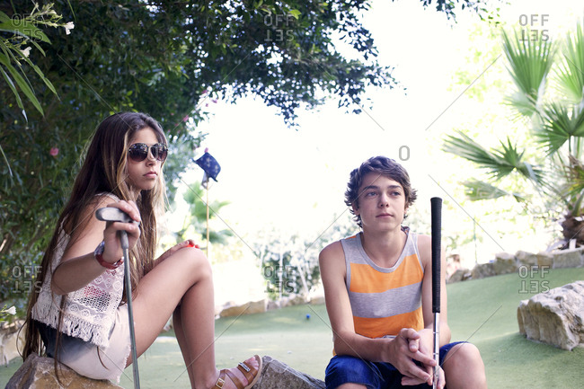 Kids sitting at minigolf course
