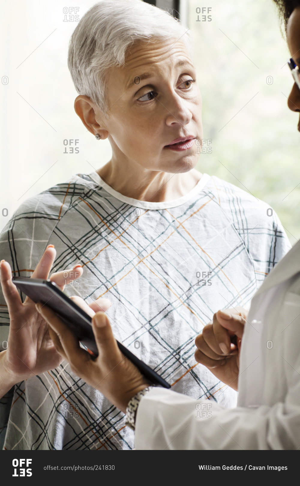 A Patient Discusses Her Prognosis With A Doctor Stock Photo - OFFSET