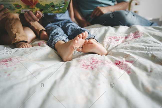 Children's' feet on a bed