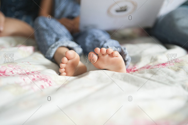 Child's feet on a bed