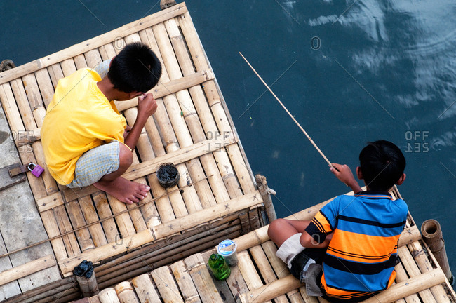 Children fishing on the river in Yogyakarta, Indonesia