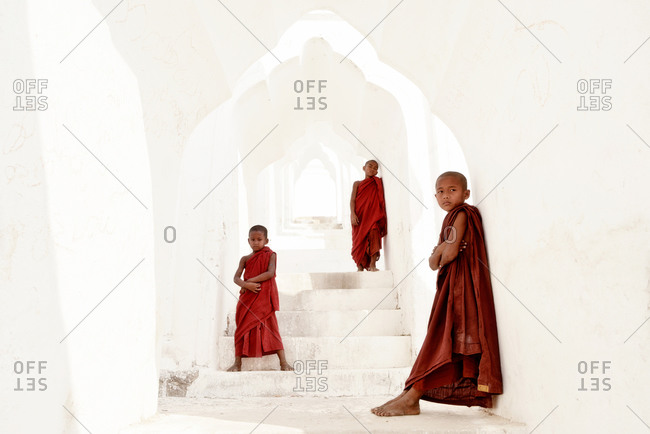 Mingun, Myanmar - March 1, 2015: Young monks at the entrance of Hsinbyume Pagoda